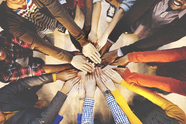 A scene of diverse individuals helping each other, symbolizing unity in love.